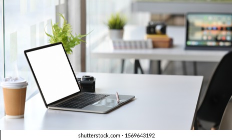 Office Room With Side View Mockup Laptop Computer, Coffee, Camera On White Table.