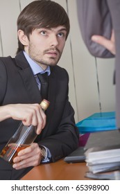 Office Scene - Businessman Hiding A Bottle Of Alcohol Under The Desk