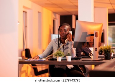 Office Secretary Answering Landline Phone Call To Talk About Business Research With Project Manager. Having Remote Conversation On Office Telephone Line, Chatting About Email Report.