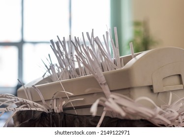 office shredder with overflowing cut paper