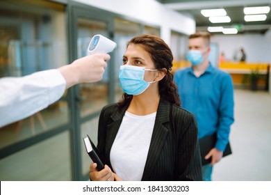 Office Staff Undergo Temperature Screening At The Entrance. Business People Back At Work In Office After Quarantine. Covid-19.