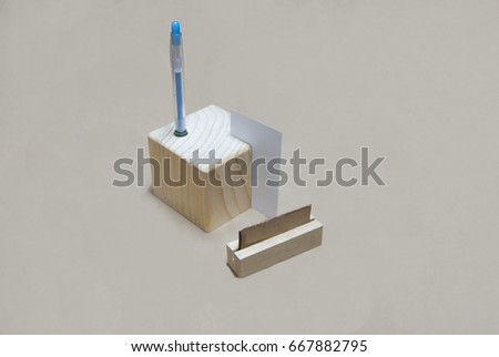 Office stationery isolated on a brown background. Stand, business card holder, pen.