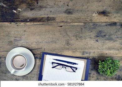 Office stuff and it gadgets display on top view business desk with copy space at text of picture. Creative table, modern project. Business empty vintage is background. Dark tone.Flat lay.
