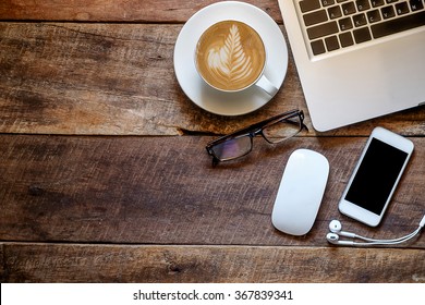 Office Stuff With Laptop Smartphone And Coffee Cup Mouse Top View Shot.