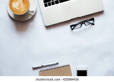 office stuff with laptop smartphone and coffee cup mouse notepad top view shot. - Shutterstock ID 420084436