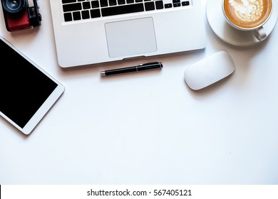 Office Stuff With Tablet, Laptop ,smartphone And Coffee Cup Notepad Top View Shot.
