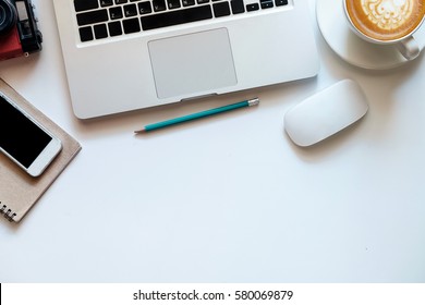 Office Stuff With Tablet, Laptop ,smartphone Pencil Mouse And Coffee Cup Notepad Top View Shot.
