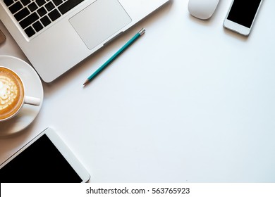 Office Stuff With Tablet,laptop,smartphone And Coffee Cup Notepad Top View Shot.