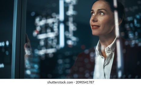 Office: Successful Businesswoman in Stylish Suit Working, Looking in Wonder at Night City. Stylish Female CEO Working Late and Hard to Create e-Commerce Online Shopping Experience Sustainable and Safe - Shutterstock ID 2090541787