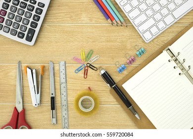 Office supplies and cup of coffee on wood table, top view - Powered by Shutterstock