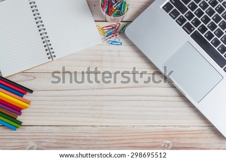 office supplies and gadgets on a wooden table background, View from above.
