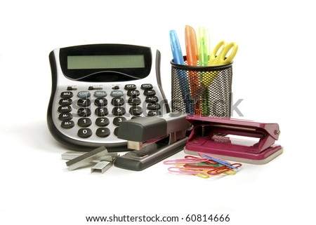 Office supplies including a calculator, punch, stapler, paperclips and scissors
