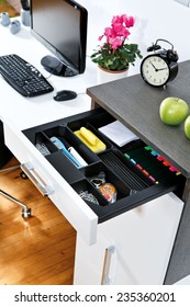 Office supplies in open desk drawer 