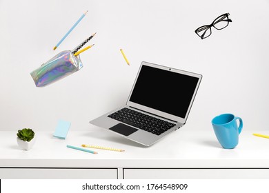 Office supplies stationery levitate over white table. Back to school work education creative layout