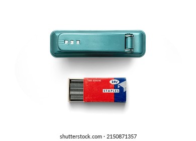 Office Supplies - Vintage Green Metal Stapler and Staple Box with staples Flatlay on White Background