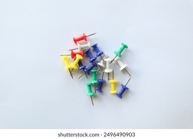 office supplies,colorful thumbtacks on a white background - Powered by Shutterstock