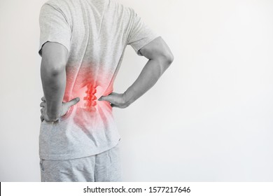 Office syndrome, Backache and Lower Back Pain Concept. a man touching his lower back at pain point - Shutterstock ID 1577217646
