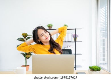 Office Syndrome Concept. Young Asian Woman Feeling Pain In Neck After Working On Computer Laptop For A Long Time