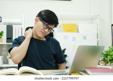 Office Syndrome Concept. Young Asian Man With Office Syndrome Have Problem With Part Of Body Arm Shoulder Head Neck Back Healthy Problem After Working On Laptop For A Long Time.
