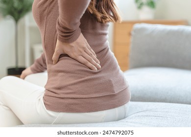 office syndrome in office worker concept, female touching her back suffering from muscle pain from sitting position during work. - Powered by Shutterstock