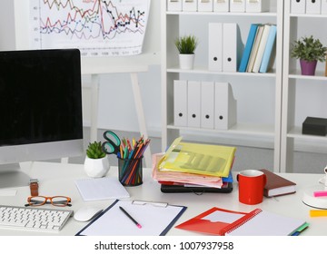 Office table with blank notepad and laptop - Shutterstock ID 1007937958