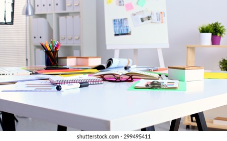 Office table with blank notepad and laptop 