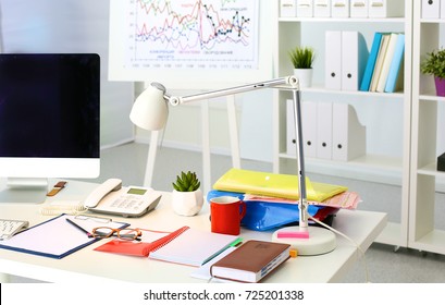 Office table with blank notepad and laptop - Shutterstock ID 725201338