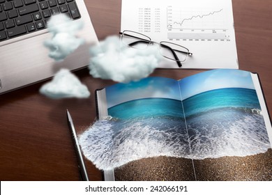 Office Table In Clouds With The Sea On The Notebook. Vacation Concept