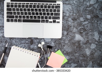 office table with computer keyboard, mouse, earphone ,notebooks and pen. Top view with copy space.