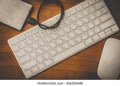Office table and computer keyboard and mouse and external harddisk with art lighting