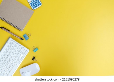 Office Table Desk From Above. On The Desk Background, There Is A Blank Workspace With Office Supplies, A Laptop, A Pencil