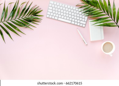 Office table desk with computer,  green leaves palm, clipboard. Magazines, social media. Top view. Flat lay. Home office workspace. Women's fashion accessories isolated on pink background.  - Powered by Shutterstock - Get 15% off with code: PIKWIZARD15