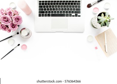 Office table desk. laptop, computer. magazines, social media. Top view. Flat lay. Home office workspace. Women's fashion. bouquet of roses, notebook, on white background. makeup tools brushes 