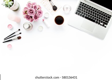 Office Table Desk. Laptop, Computer. Magazines, Social Media. Top View. Flat Lay. Home Office Workspace. Women's Fashion. Bouquet Of Roses, Notebook, Coffee On White Background. Makeup Tools Brushes 