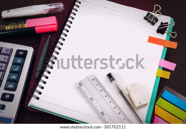 Office table desk or school supplies on table.\
School and office tools on office table. Desk with notebook or\
paper note and stationery object on office desk. Office desk\
concept. Math supplies.