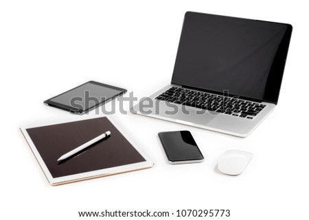Office table with laptop computer, digital tablet, smartphone, pencil and mouse on isolated pure white background / Laptop and tablet mockup concept. (Selective Focus)
