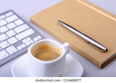 office table with notebook, computer keyboard,, cup of coffee, tablet pc. copy space.