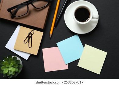 Office table with notebook, paper sticky notes and cup of coffee, top view - Powered by Shutterstock