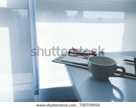 office table with notebook put a pen and glasses in modern office With coputer notebook