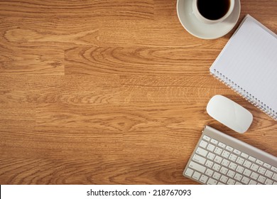 Office Table With Notepad, Computer And Coffee Cup And Computer Mouse. View From Above With Copy Space