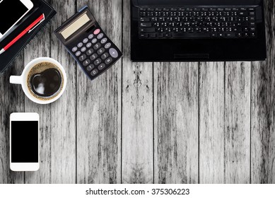 Office table with notepad, computer and coffee cup. View from above with copy space