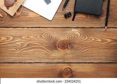 Office table with notepad, vintage envelope and supplies. View from above with copy space - Powered by Shutterstock