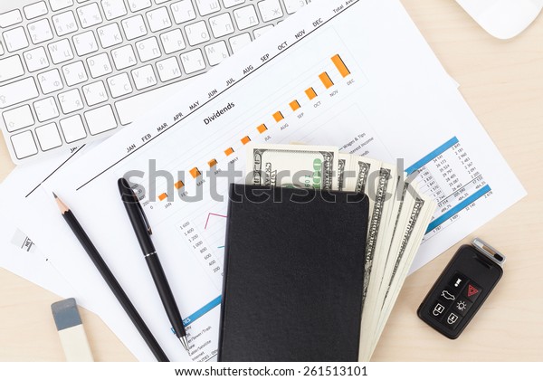 Office table with pc, supplies and money cash. View
from above
