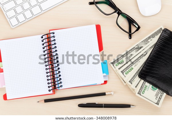 Office table with pc, supplies and money cash. View\
from above with copy\
space