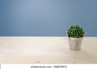 Office Table With Tree On Basket,  View From Front With Green Leaf.