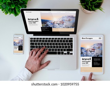 Office Tabletop With Tablet, Smartphone And Laptop Showing Travel Responsive Design Website