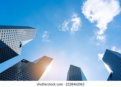 Office tall building. Low angle view of skyscrapers modern office building city in business center with blue sky - Shutterstock ID 2228462063