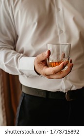 in the office there is a man with a glass of whiskey in a white shirt, vertical picture, male mood, focus on alcohol, relax after a hard day, strong arm, bourbon in a stressful situation - Shutterstock ID 1773715892