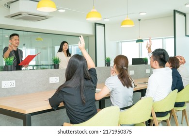 Office Training In Progress With Trainees Raising Hands To Ask Questions. Co Working Office Setting.