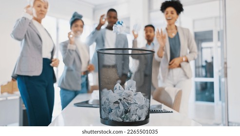 Office, trash and business people throw paper as a competition, game or challenge together. Happy, diversity and excited corporate team playing with with supplies in a bin for fun in the workplace. - Powered by Shutterstock